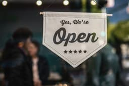 A small business open sign in a storefront window